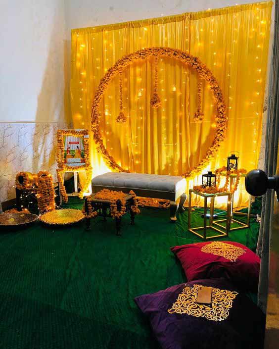 Yellow floral ring and candle mehndi stage decor at home