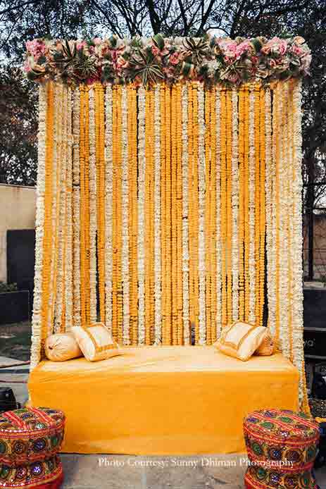 Orange and white floral canopy decor for mehndi stage