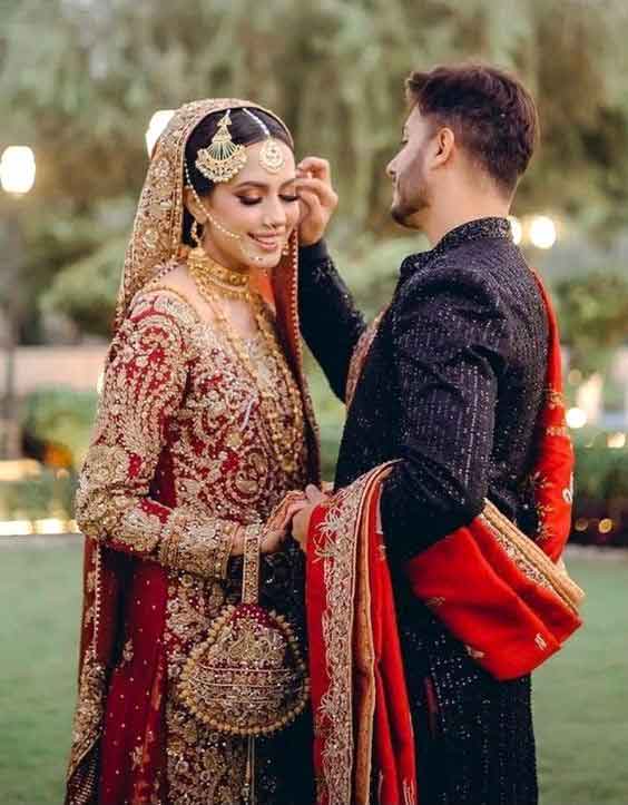 Barat couple pose for bride and groom