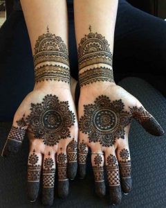 Rounded mehndi designs on palms and front hands