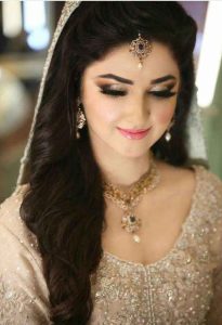 Pakistani engagement makeup with off white bridal dress