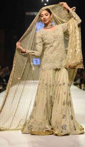 Latest golden shirt with sharara for Pakistani engagement brides