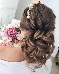 Twisted hair bun with flowers hairstyle for engagement