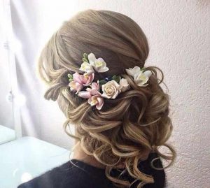 Flower adorned hair bun for engagement brides